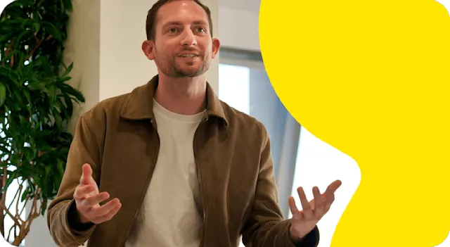 A photo of a Trustpilot employee speaking at a meeting